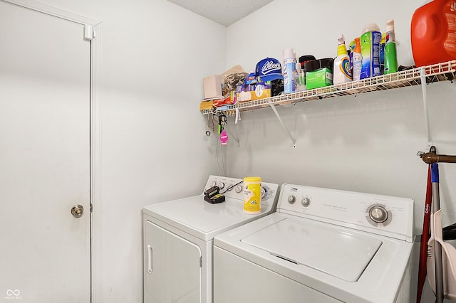 washroom featuring laundry area and washing machine and clothes dryer