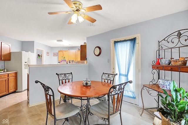 dining room featuring light tile patterned floors, visible vents, and ceiling fan