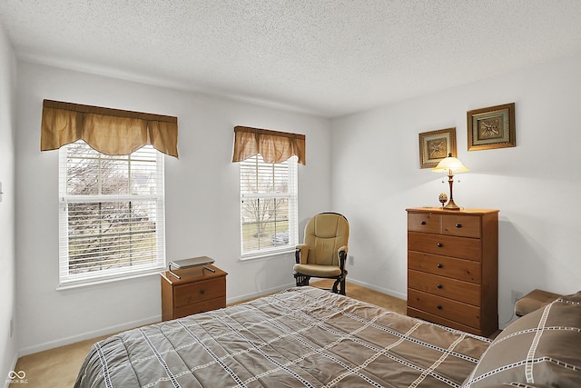 carpeted bedroom with baseboards and a textured ceiling