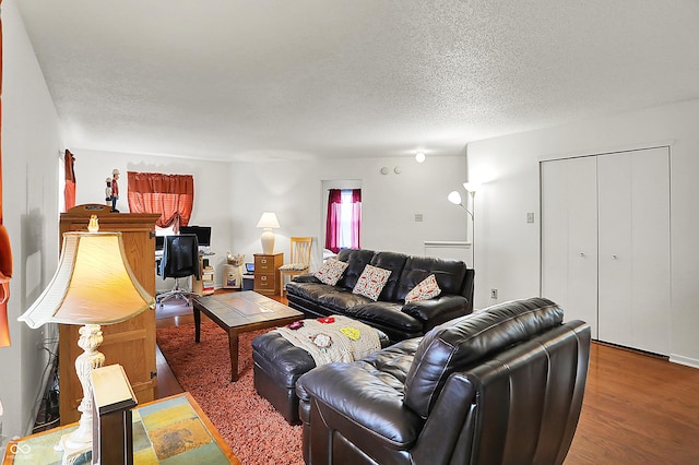 living area featuring a textured ceiling and wood finished floors