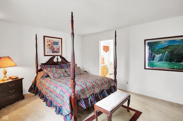 bedroom with light colored carpet and connected bathroom