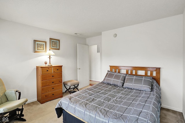 carpeted bedroom with visible vents, a textured ceiling, and baseboards