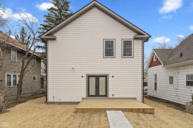 back of property featuring a deck and french doors