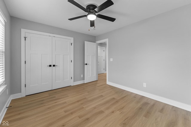 unfurnished bedroom with light wood finished floors, a ceiling fan, baseboards, and a closet