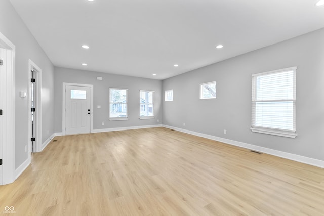 interior space with recessed lighting, visible vents, light wood-style flooring, and baseboards