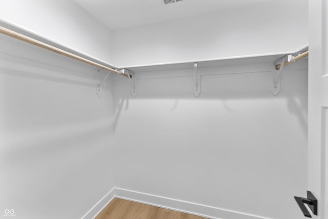 spacious closet with light wood finished floors and visible vents