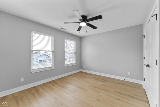 empty room with light wood-style flooring and baseboards