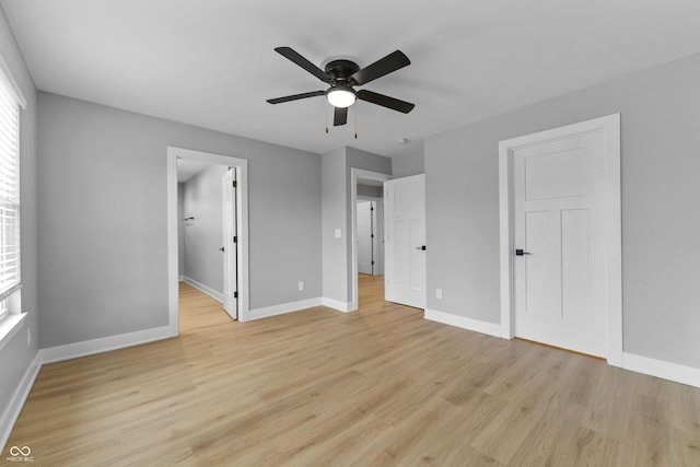 unfurnished bedroom featuring light wood-style floors, ceiling fan, and baseboards