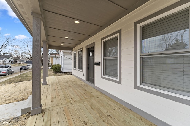 wooden terrace featuring covered porch