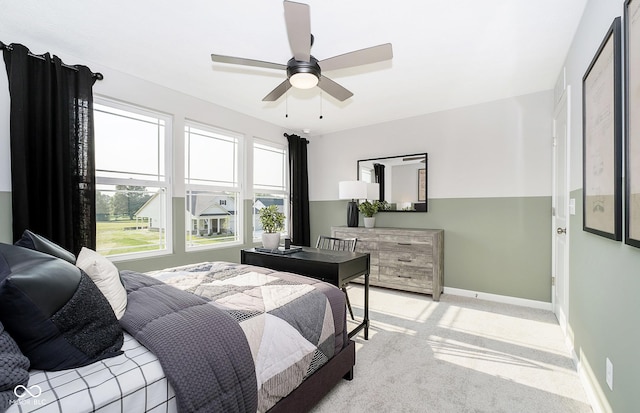 bedroom with baseboards, a ceiling fan, and light colored carpet