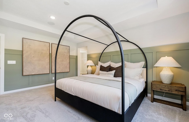 bedroom featuring recessed lighting, a wainscoted wall, carpet flooring, and a decorative wall