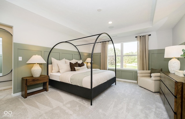 bedroom with recessed lighting, a raised ceiling, light carpet, and baseboards