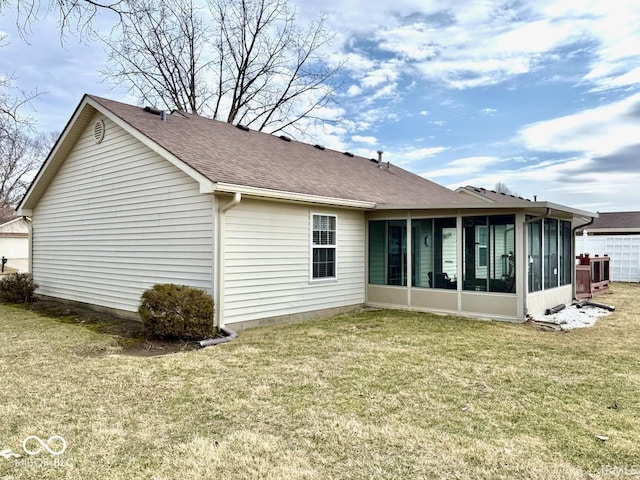 back of property with central air condition unit, a sunroom, a shingled roof, and a lawn