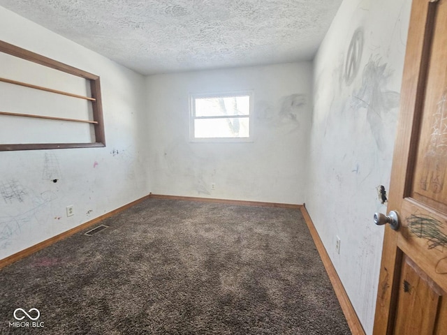 unfurnished room with visible vents, carpet flooring, a textured ceiling, and baseboards