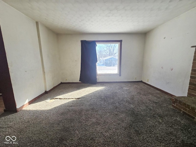 carpeted empty room with baseboards