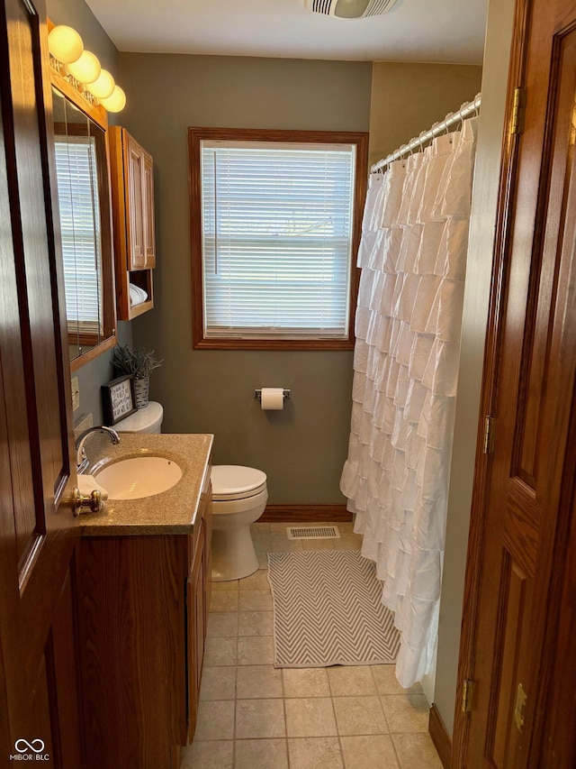 bathroom with vanity, tile patterned floors, toilet, and visible vents