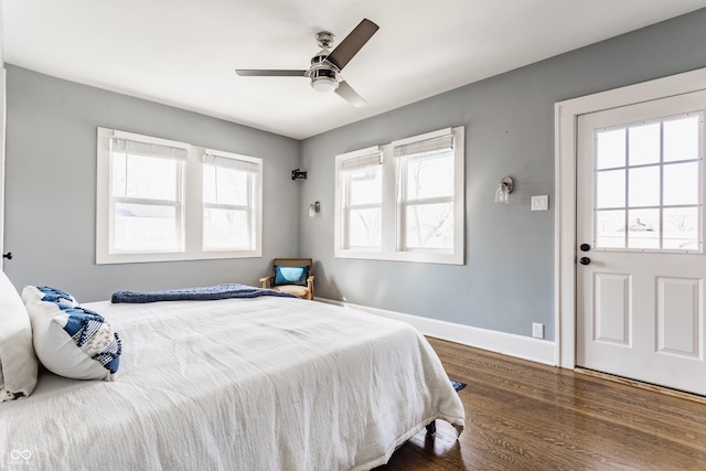 bedroom with a ceiling fan, dark wood-type flooring, and baseboards