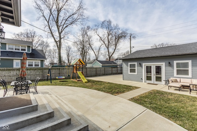 view of patio / terrace featuring an outdoor hangout area, french doors, a playground, and a fenced backyard