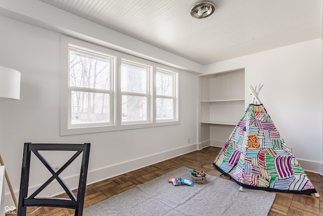 recreation room featuring baseboards