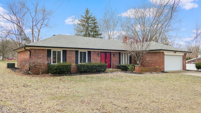 ranch-style house featuring a garage, brick siding, a front lawn, and a shingled roof