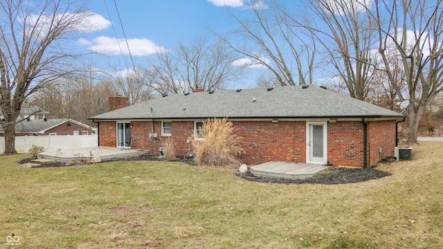 rear view of property with a patio, fence, cooling unit, brick siding, and a chimney