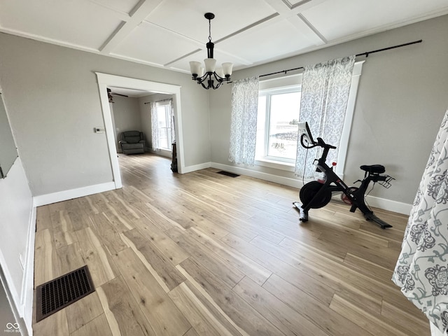 workout area with coffered ceiling, visible vents, light wood-style floors, and baseboards