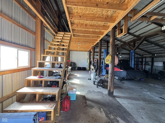 interior space with metal wall and vaulted ceiling