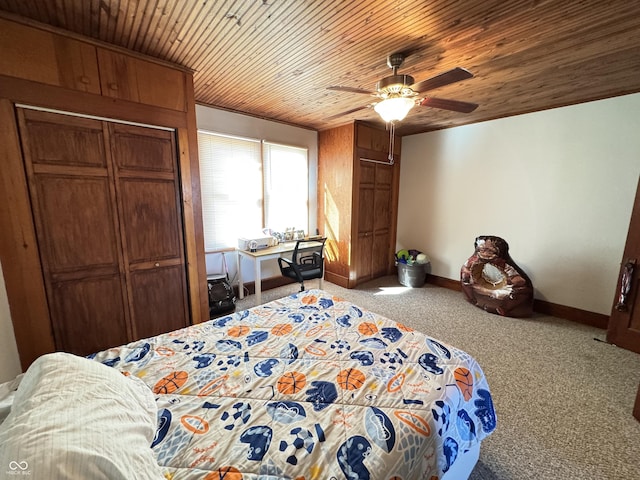 bedroom with wood ceiling, carpet, baseboards, and a ceiling fan