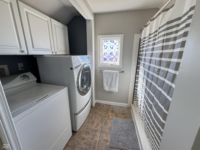 laundry area with cabinet space, baseboards, and washer and dryer