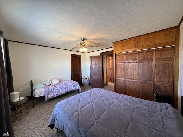 carpeted bedroom with radiator, ceiling fan, a textured ceiling, and multiple closets