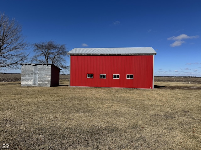 view of pole building with a yard