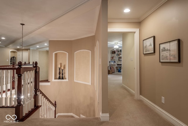 corridor featuring baseboards, carpet floors, recessed lighting, ornamental molding, and an upstairs landing