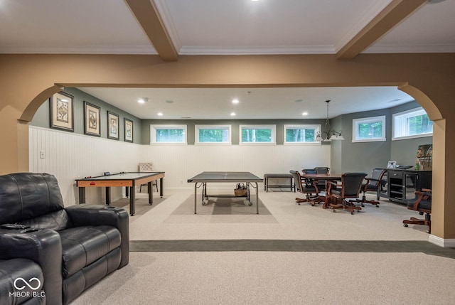 rec room featuring arched walkways, beamed ceiling, crown molding, and carpet