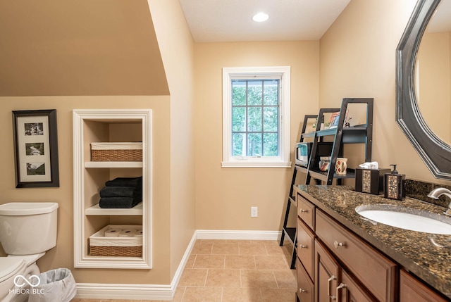 bathroom featuring vanity, built in features, baseboards, recessed lighting, and tile patterned flooring