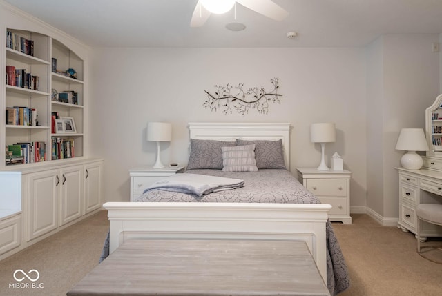 bedroom with ceiling fan, baseboards, and light carpet