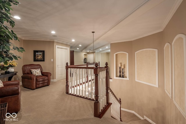 corridor with carpet, baseboards, recessed lighting, crown molding, and an upstairs landing