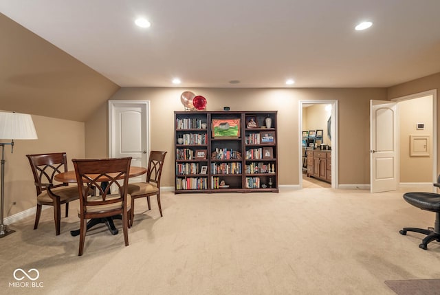 home office featuring recessed lighting, light colored carpet, lofted ceiling, and baseboards