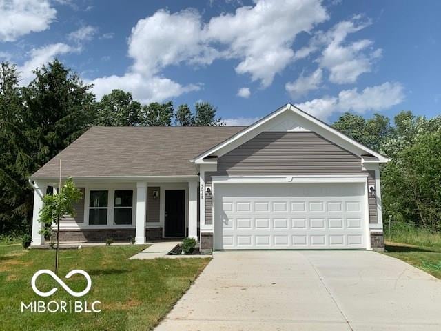 ranch-style home featuring an attached garage, concrete driveway, and a front yard