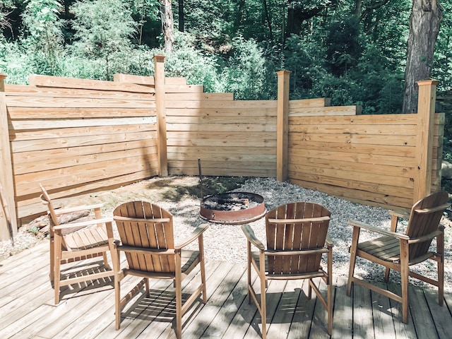 wooden terrace with a fire pit