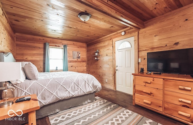 bedroom featuring wood walls, wood ceiling, and dark wood-type flooring