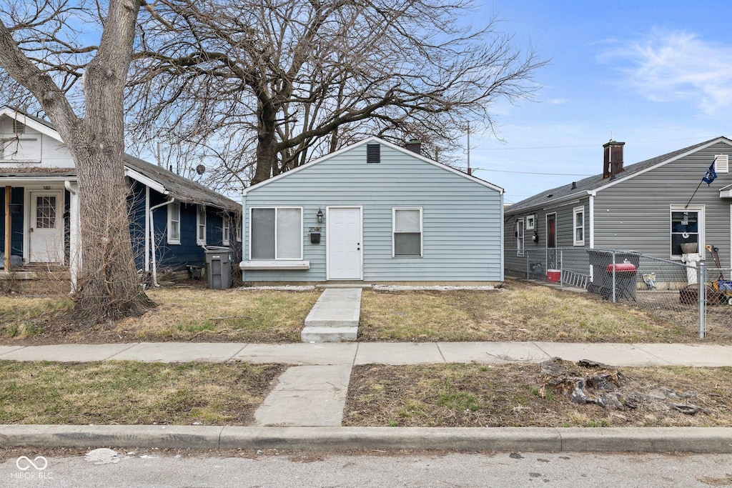 bungalow-style home featuring fence