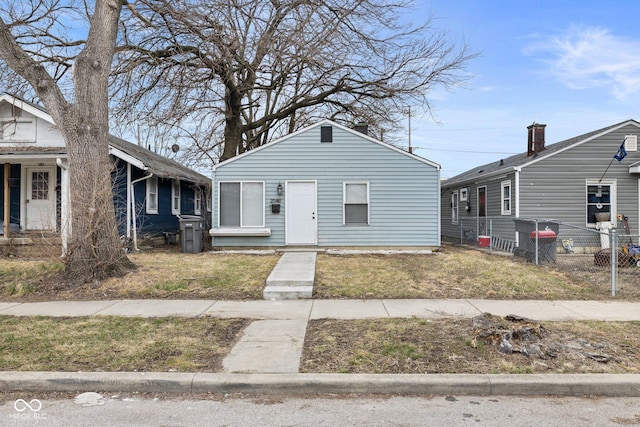 bungalow-style home featuring fence