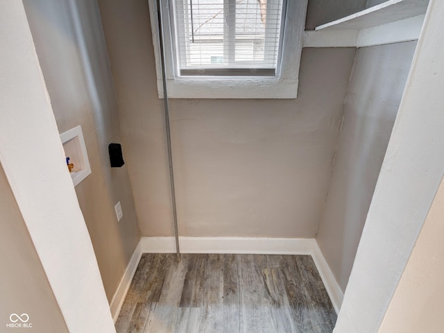 laundry room featuring hookup for a washing machine, wood finished floors, baseboards, and laundry area