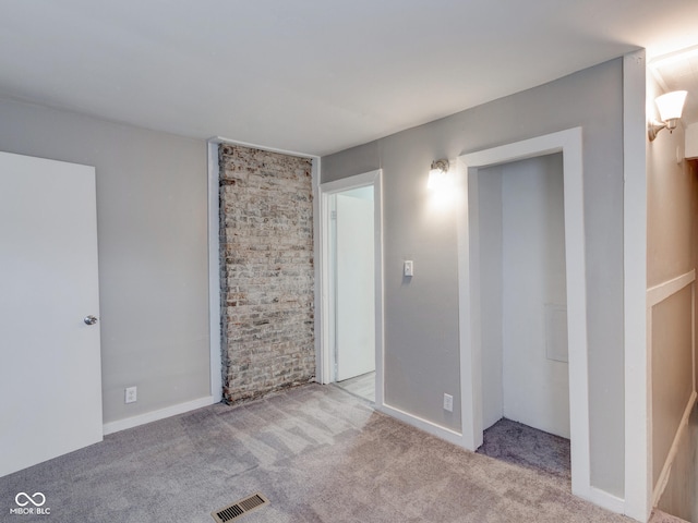 carpeted spare room with visible vents