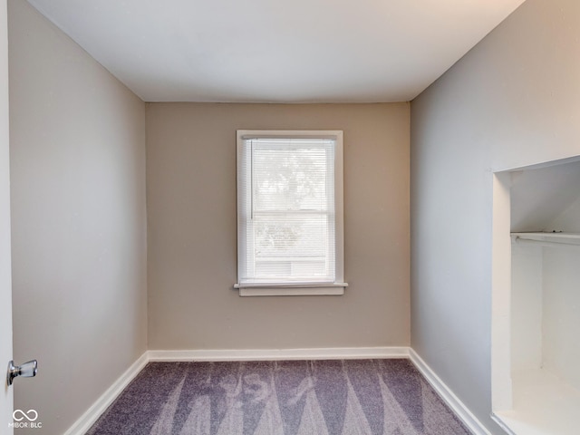 empty room with baseboards and carpet floors