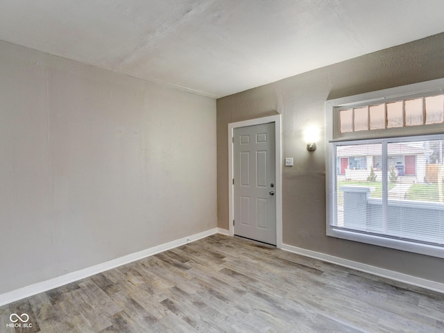 unfurnished room with wood finished floors and baseboards