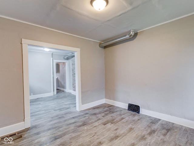 unfurnished room featuring baseboards and wood finished floors