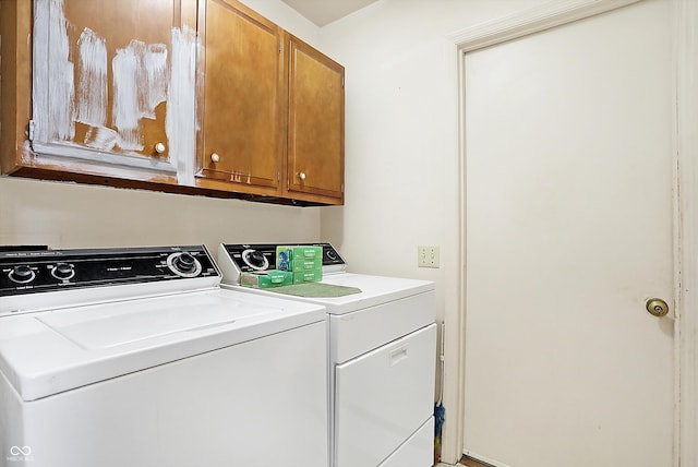 clothes washing area with cabinet space and washer and clothes dryer