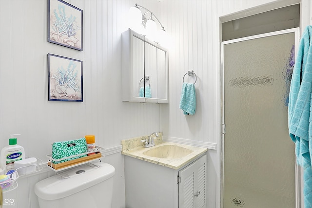 full bathroom featuring vanity, a shower stall, and toilet