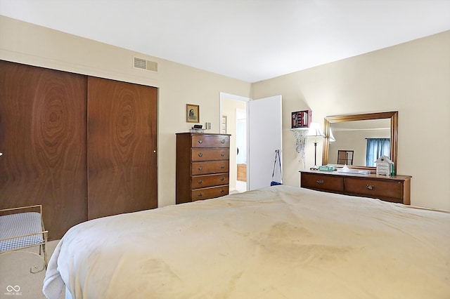 bedroom with a closet and visible vents